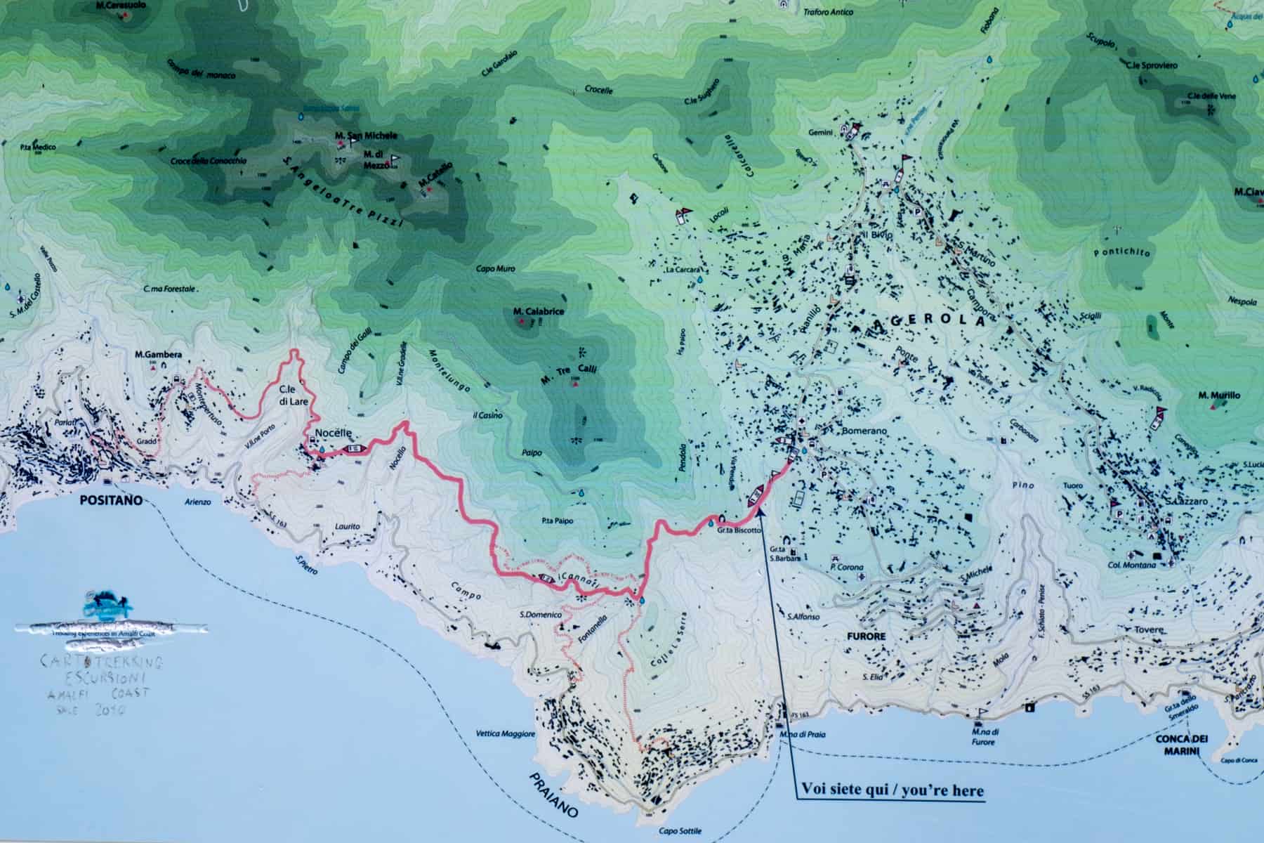 A map of the Path of the Gods hike shown by the red line through a mountainous terrain. 