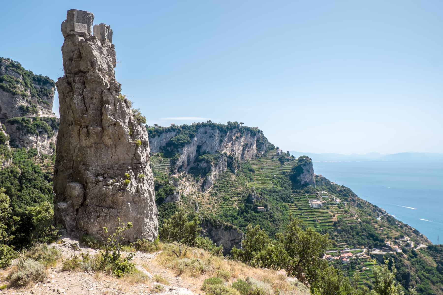 A tall rock on a cliff face in the Latteri Mountains above the Amalfi Coast, Italy. 