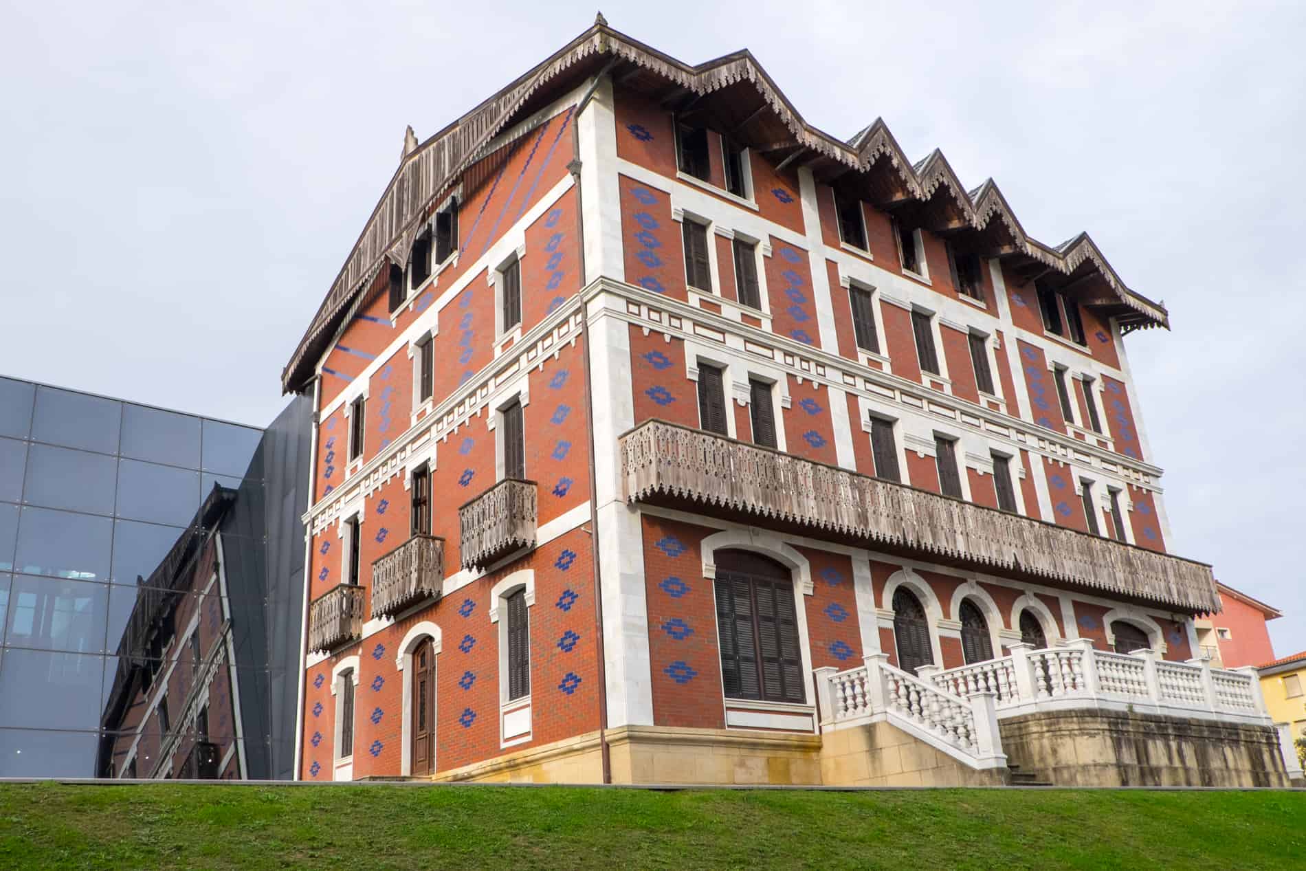 The ochre red and blue diamond design on the facade of the Balenciaga house in Getaria, Spain. 