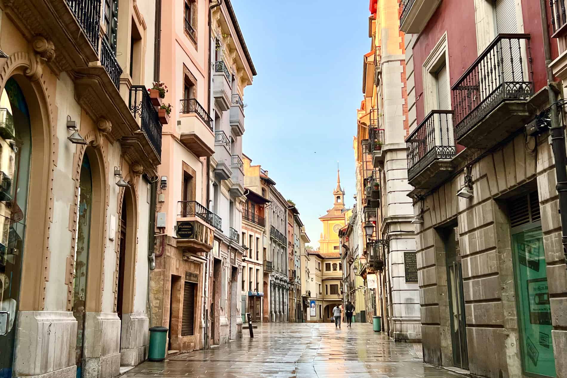 A street in the old quarter of Oviedo, Spain, bathed in the golden glow of the early morning light. 