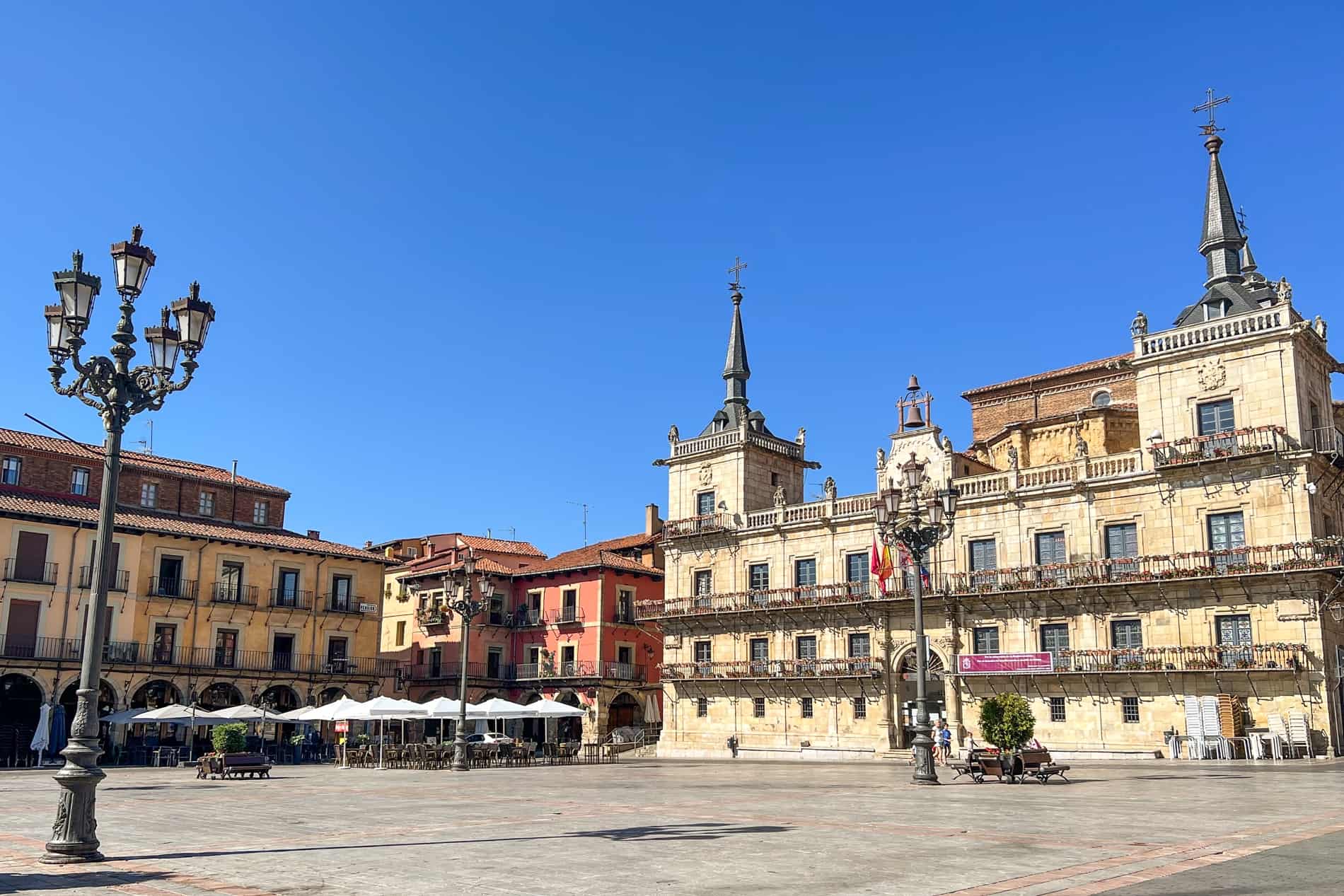 A grand twin-spire building in a large square of Plaza Mayor in León, Spain. 