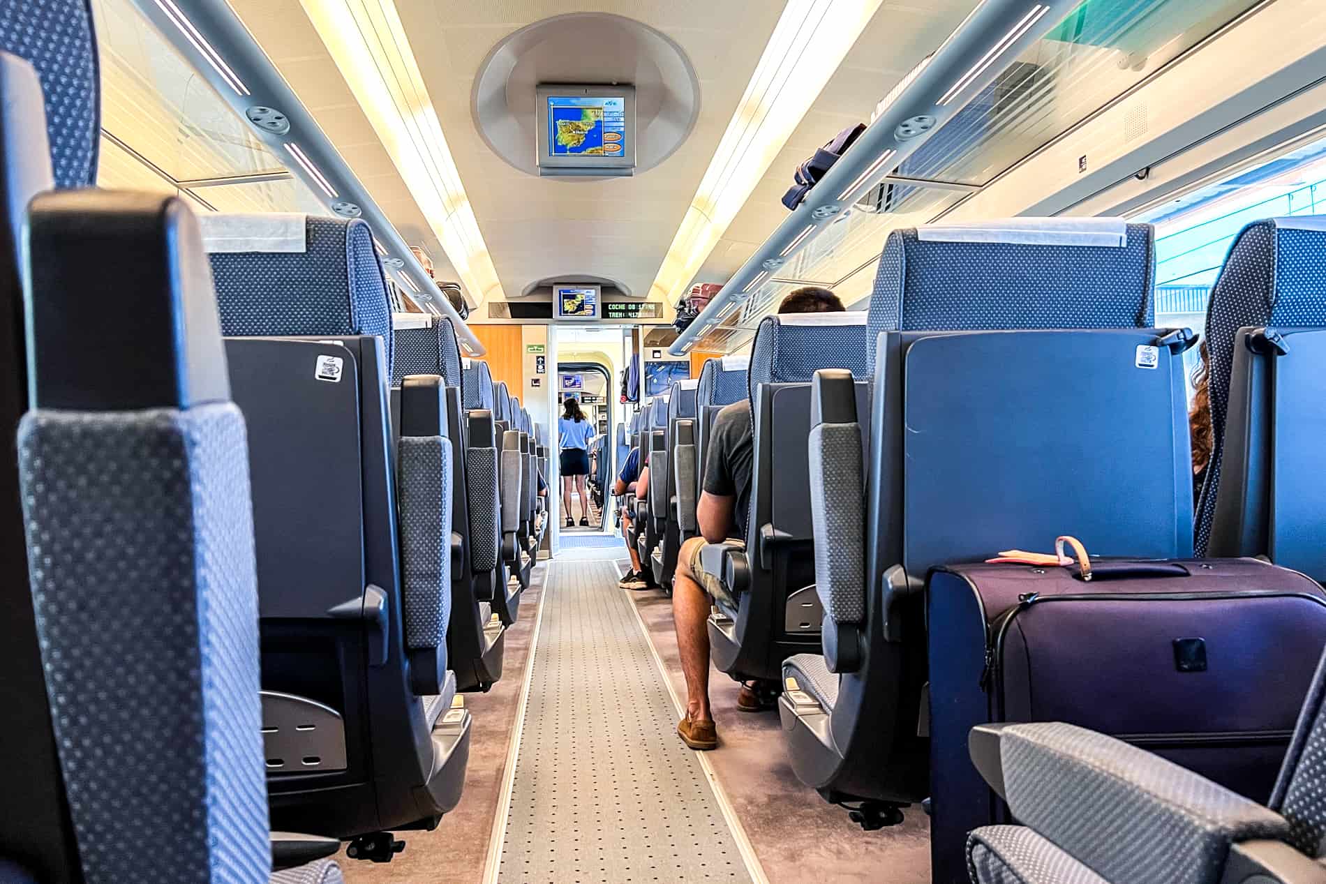 Blue seats inside a carriage on a Spanish Renfe train.