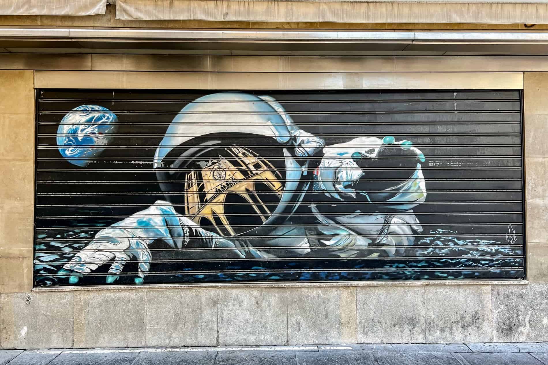 Street art of an astronaut in space, with the reflection of León cathedral in his visor. 