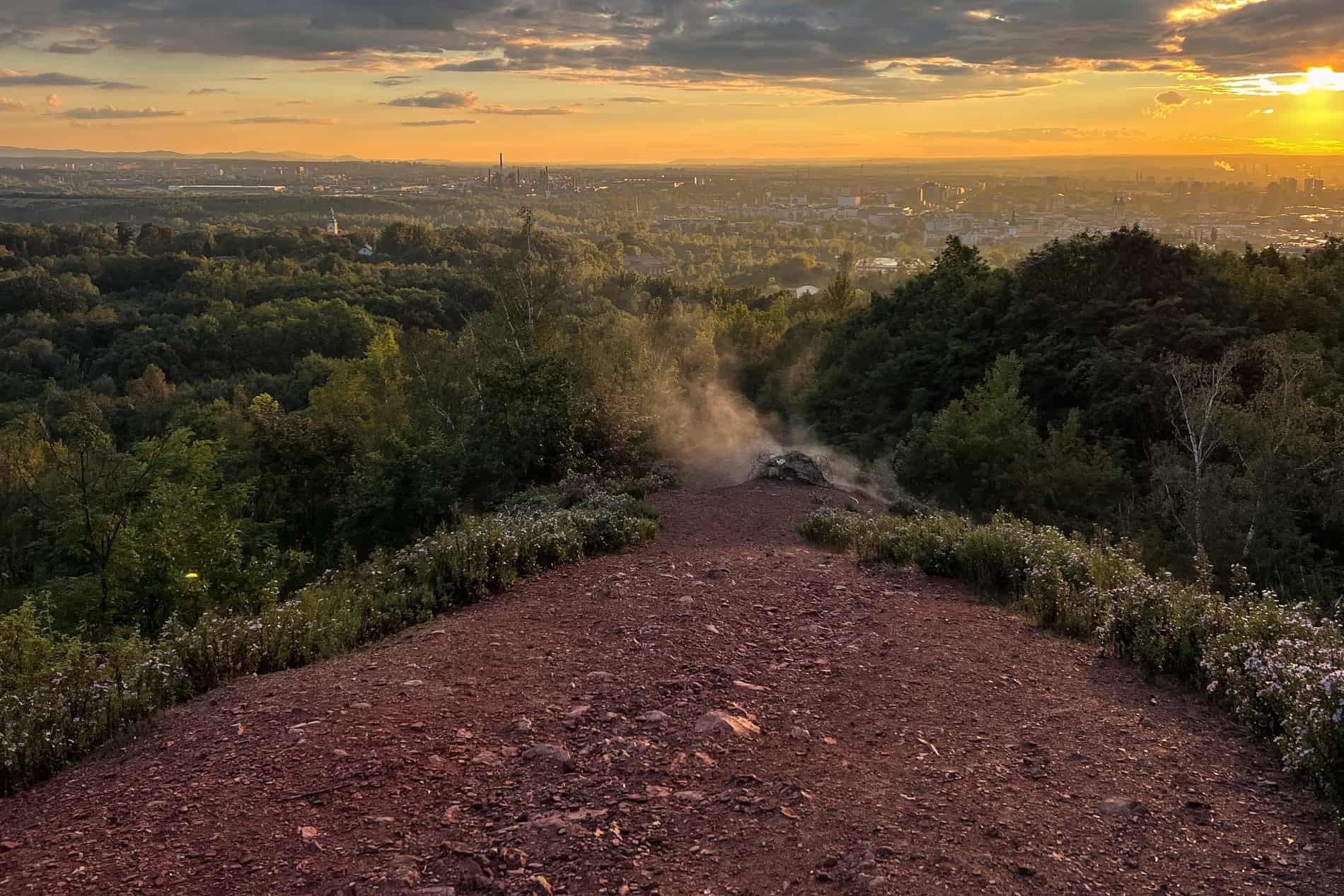 View from the smoking hilltop of Mound Ema in Ostrava overlooking woodland the wider city. 