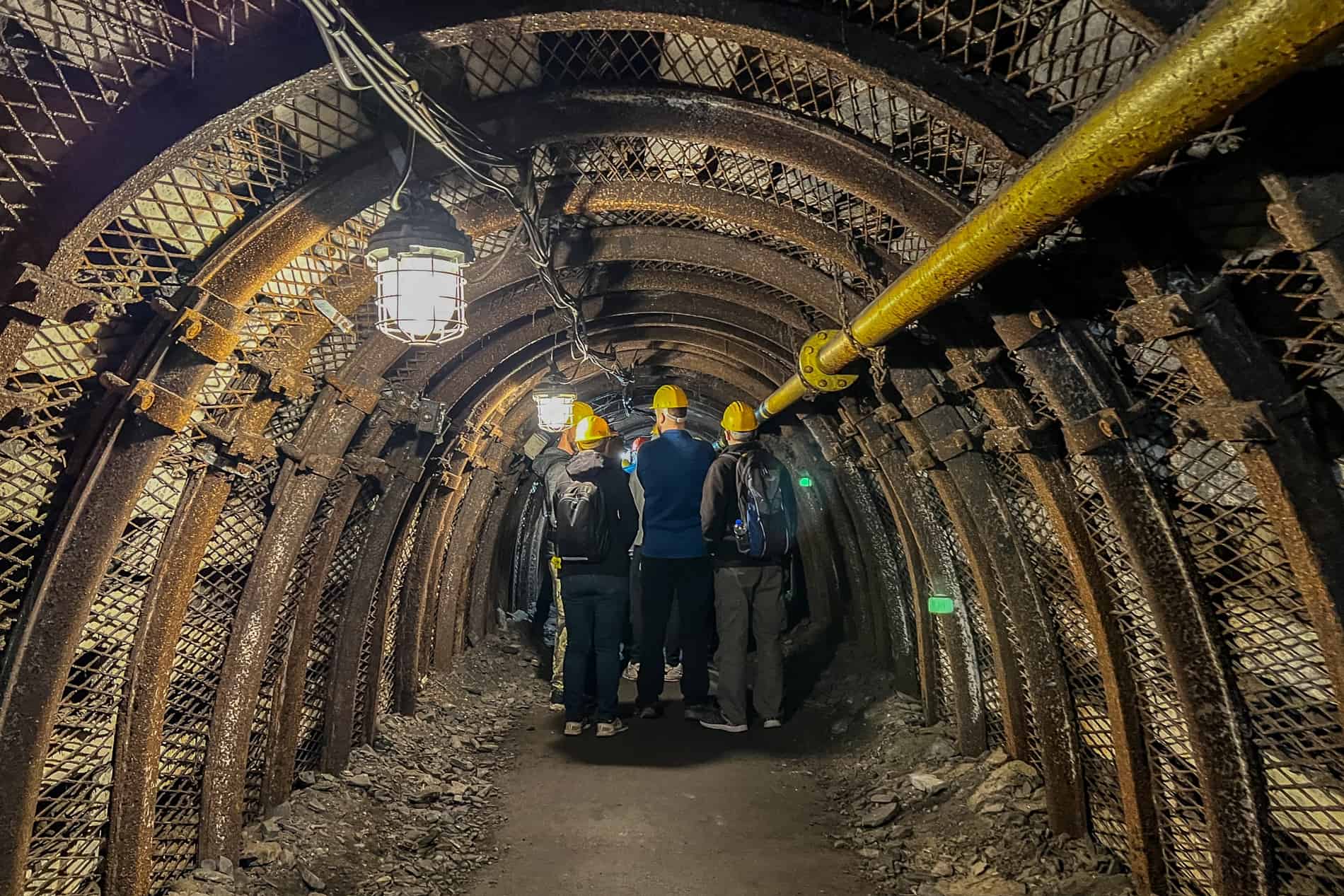 People wearing yellow helmets in a mine shaft tunnel in Ostrava. 