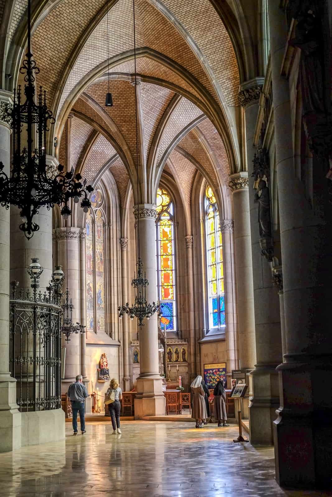 Inside the Mariendom - the biggest church in Austria - with its ornate archways and modern art stained glass windows. 