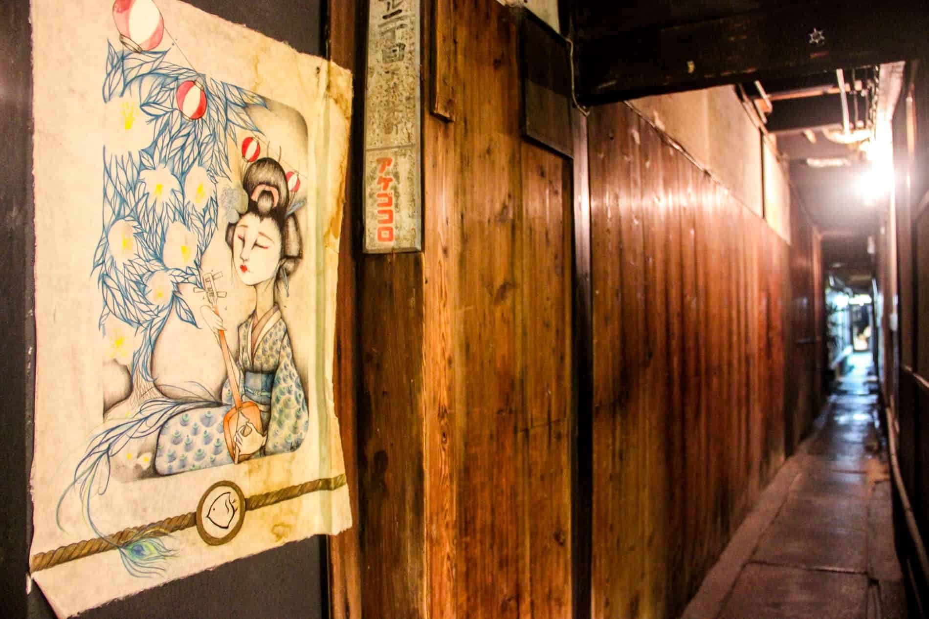 A painting of a Geisha pasted on a wooden wall in a narrow alley in the Gion District of Kyoto, Japan. 