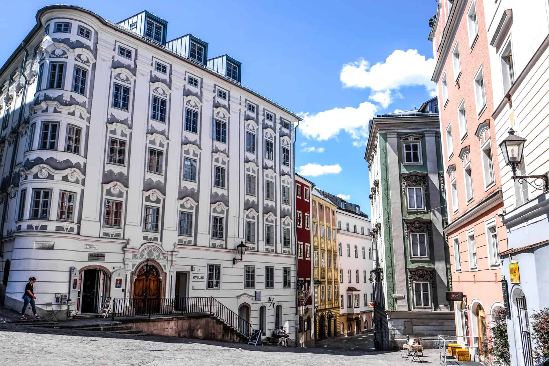 Imperial Habsburg era buildings in muted candy colours in the Old Town of Linz, Austria. 