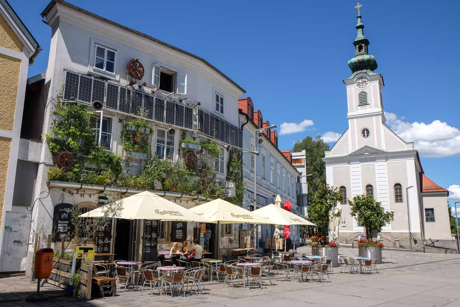 A modern cafe next to a church in the old town of Linz. 