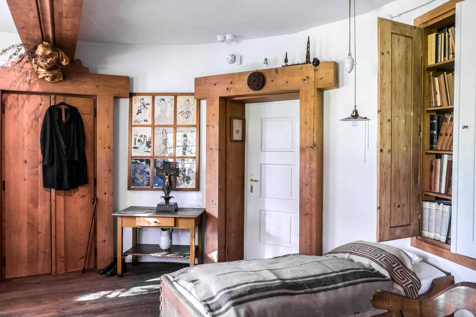 The bedroom with wooden panelled details and small bed inside Plecnik's house in Ljubljana. 