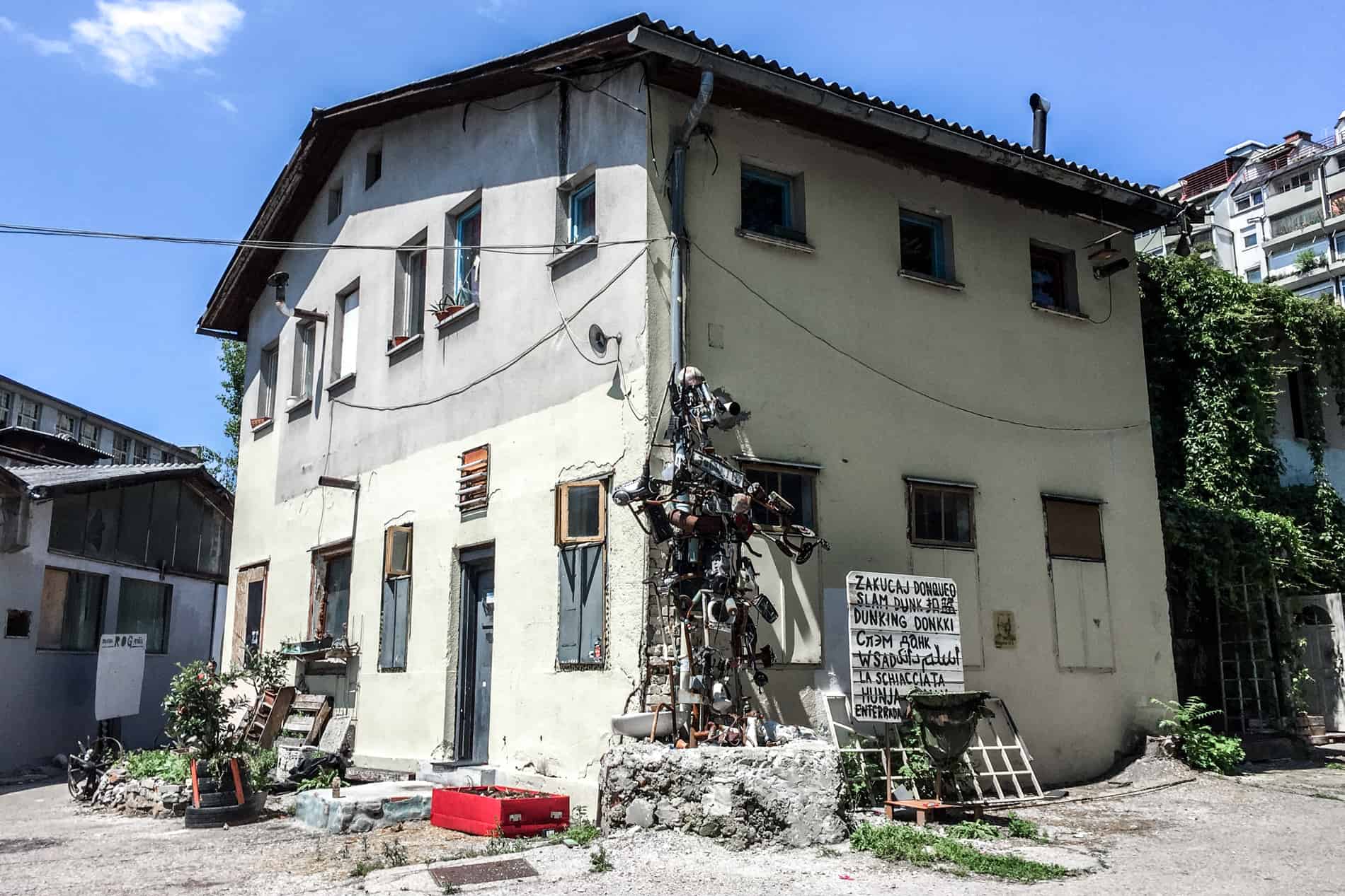 Art sculptures and a large studio building inside the Rog Factory in Ljubljana, Slovenia.