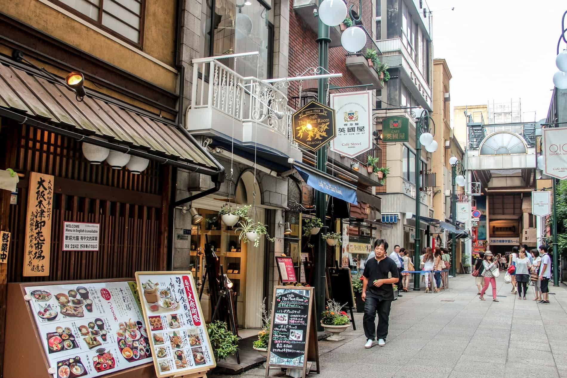 A small street in Osaka lined back-to-back with cafes.