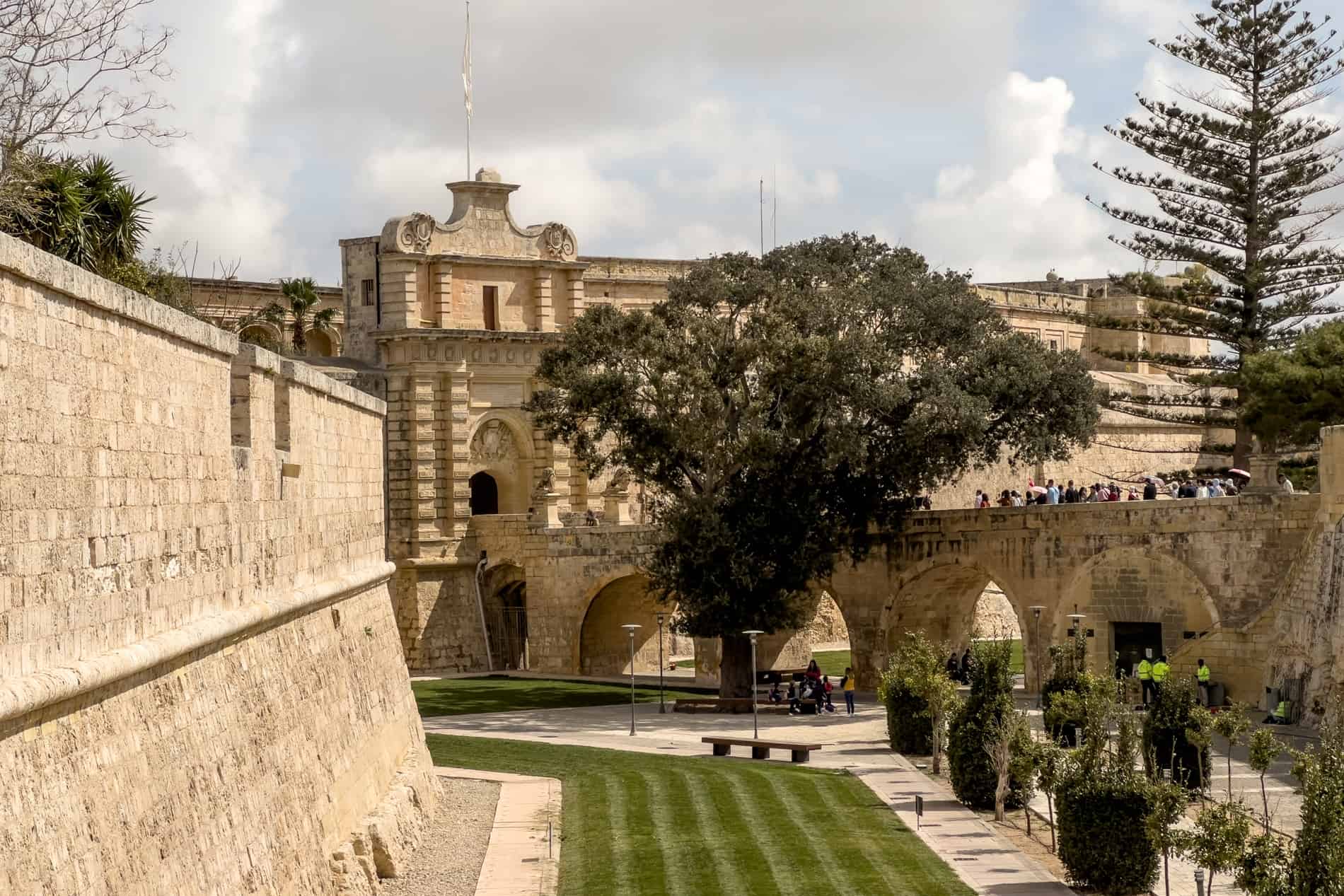 The honey-coloured stoned defensive walls and grand gate of the fortified city of Mdina, Malta. 
