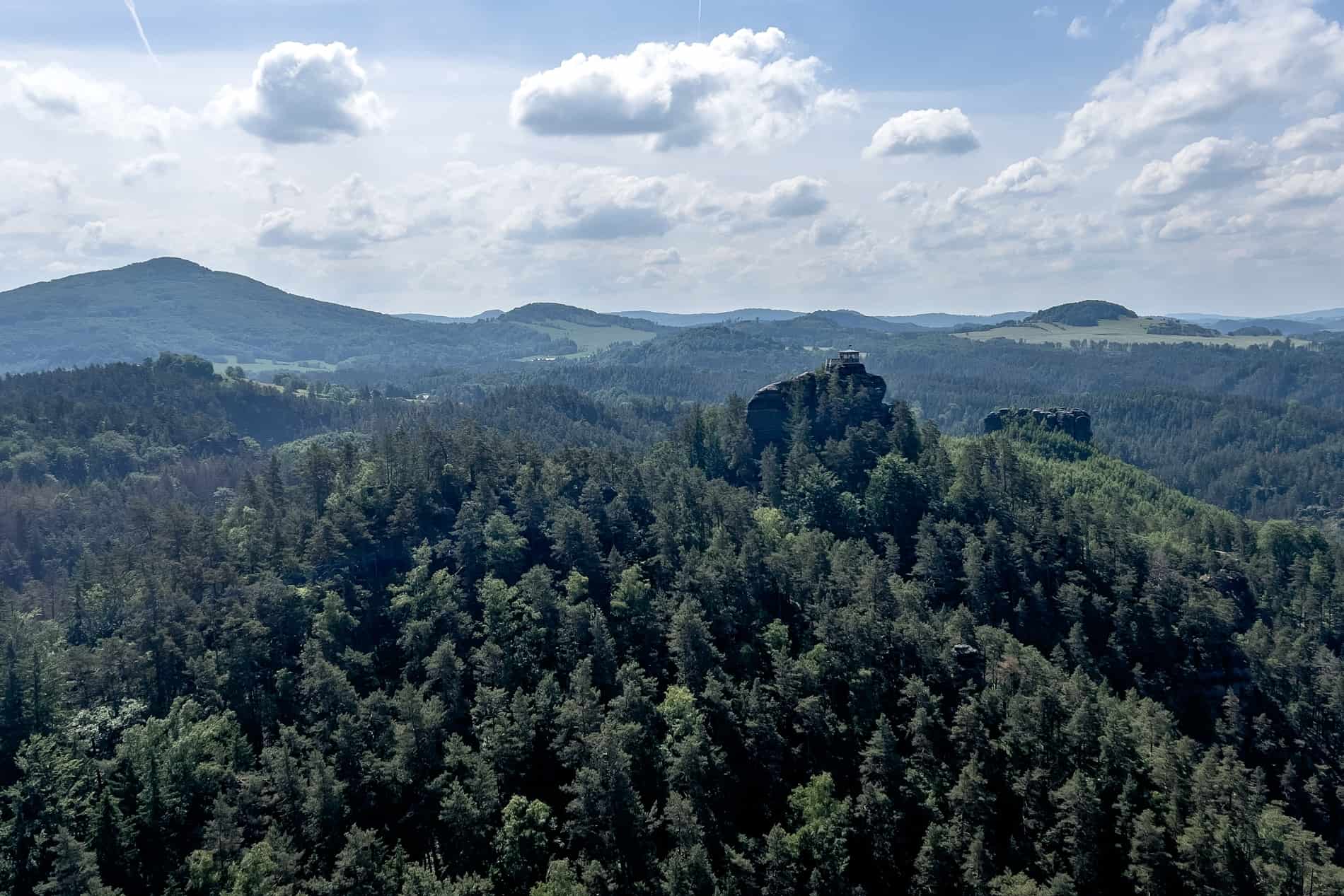 A viewing pavilion on top of a rock protruding from thick forest in Bohemian Switzerland, Czech Republic. 