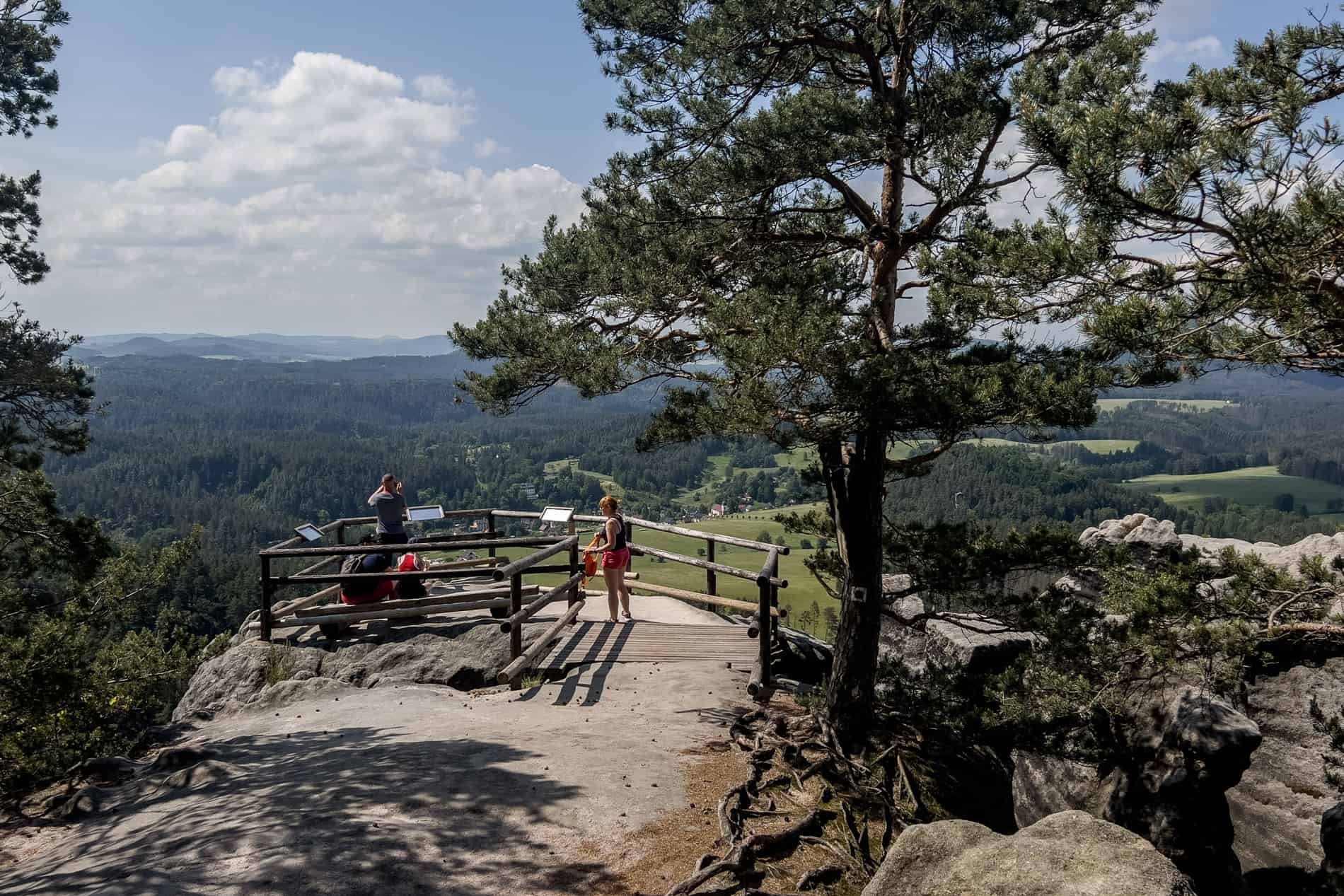 Visitors looking at the view across Bohemian Switzerland National Park from the Vilemina Wall (Vilemínina Stěna). 