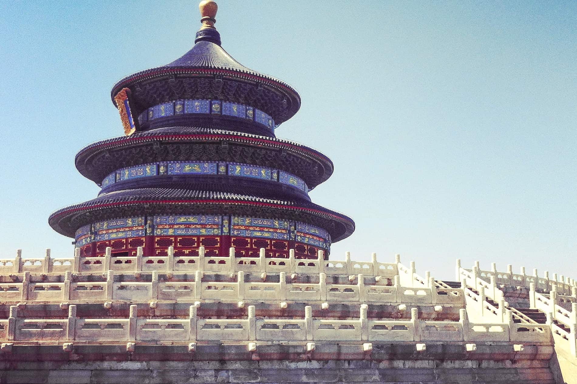 White stairs leading to the blue and red decorated cylindircal, tiered Chinese Hall of Prayer for Good Harvests at the Temple of Heaven, Beijing. 