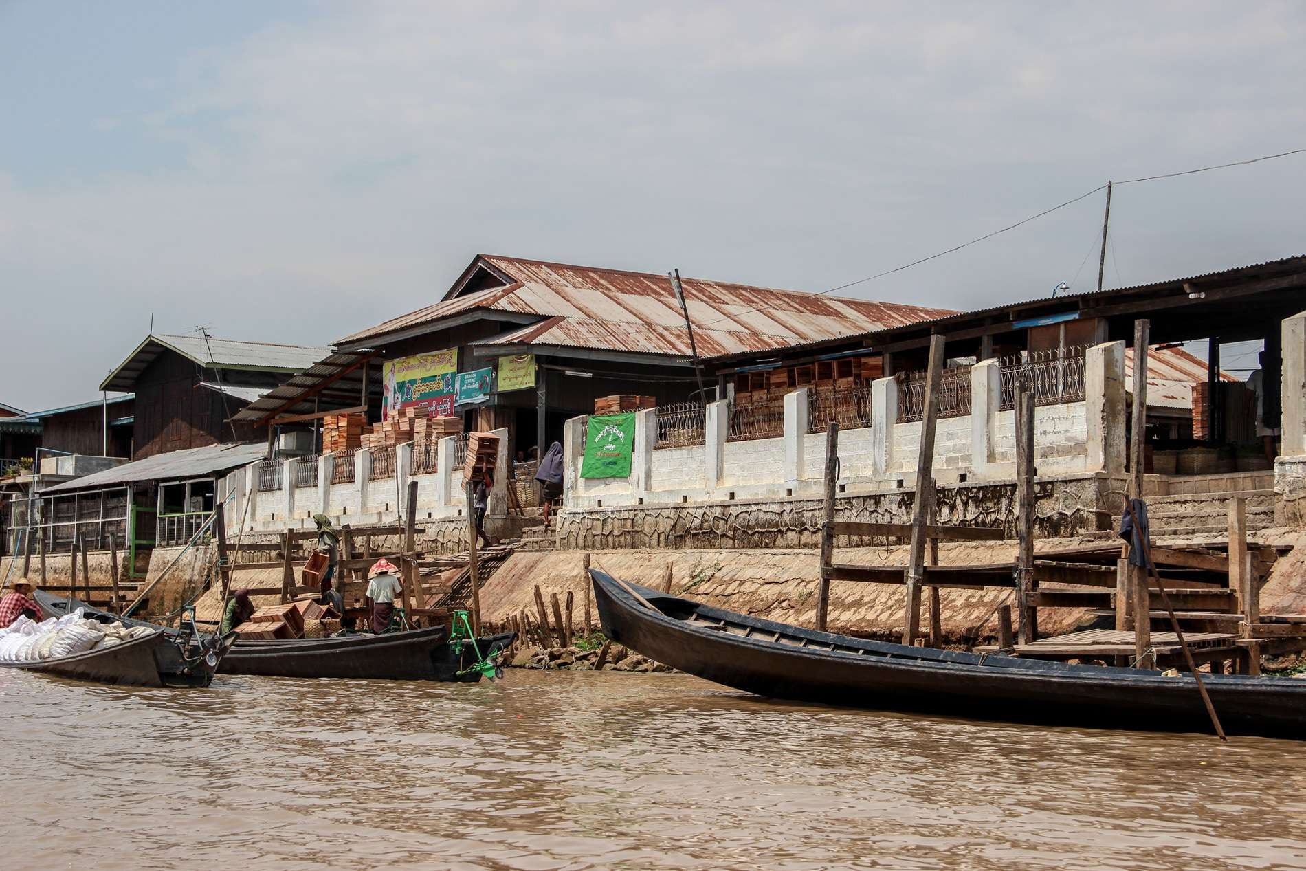 Men loading their boats with bricks for transportation across the lake. 