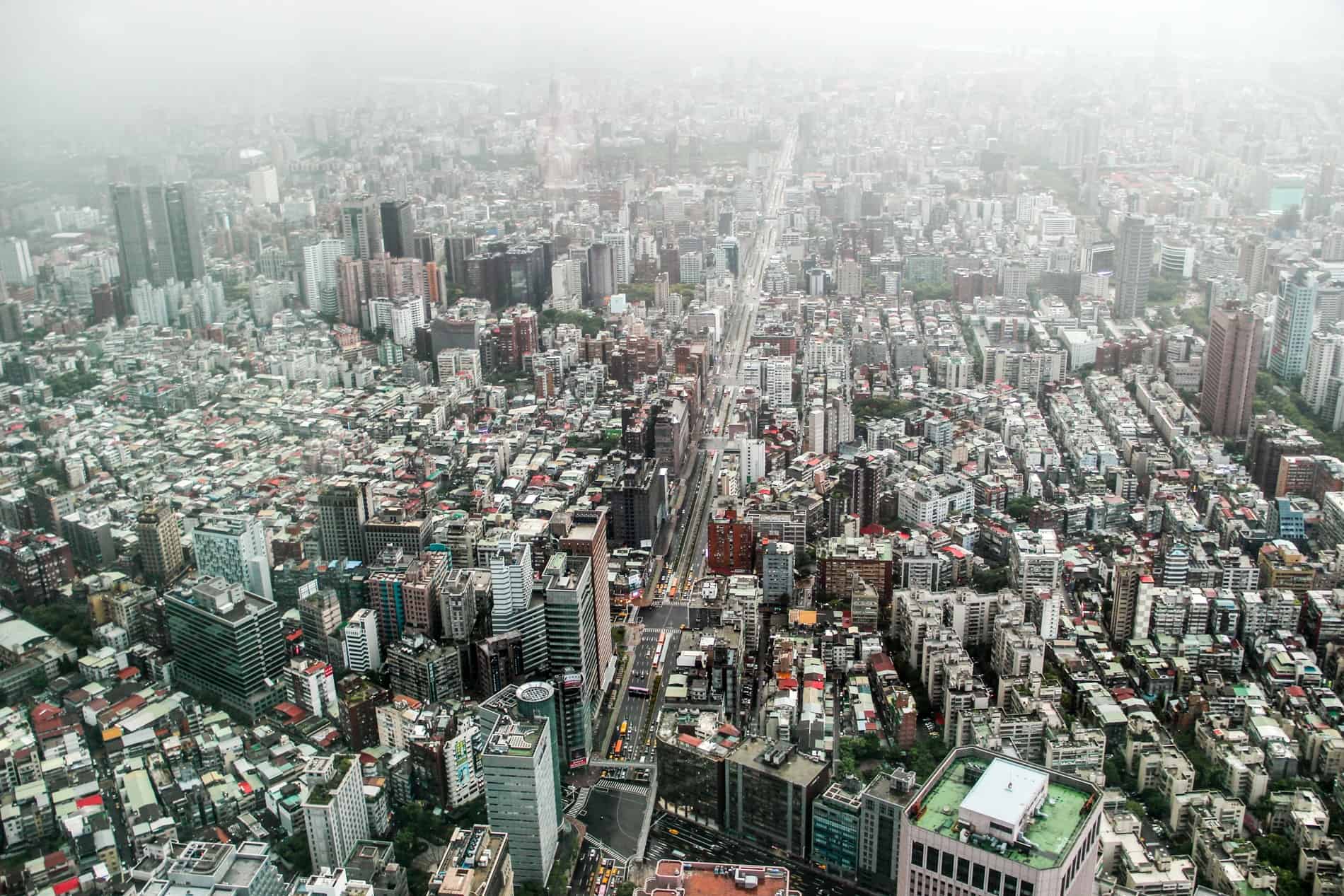 Elevated views over the densely packed Taipei city from the heights of its 101 observation deck. 