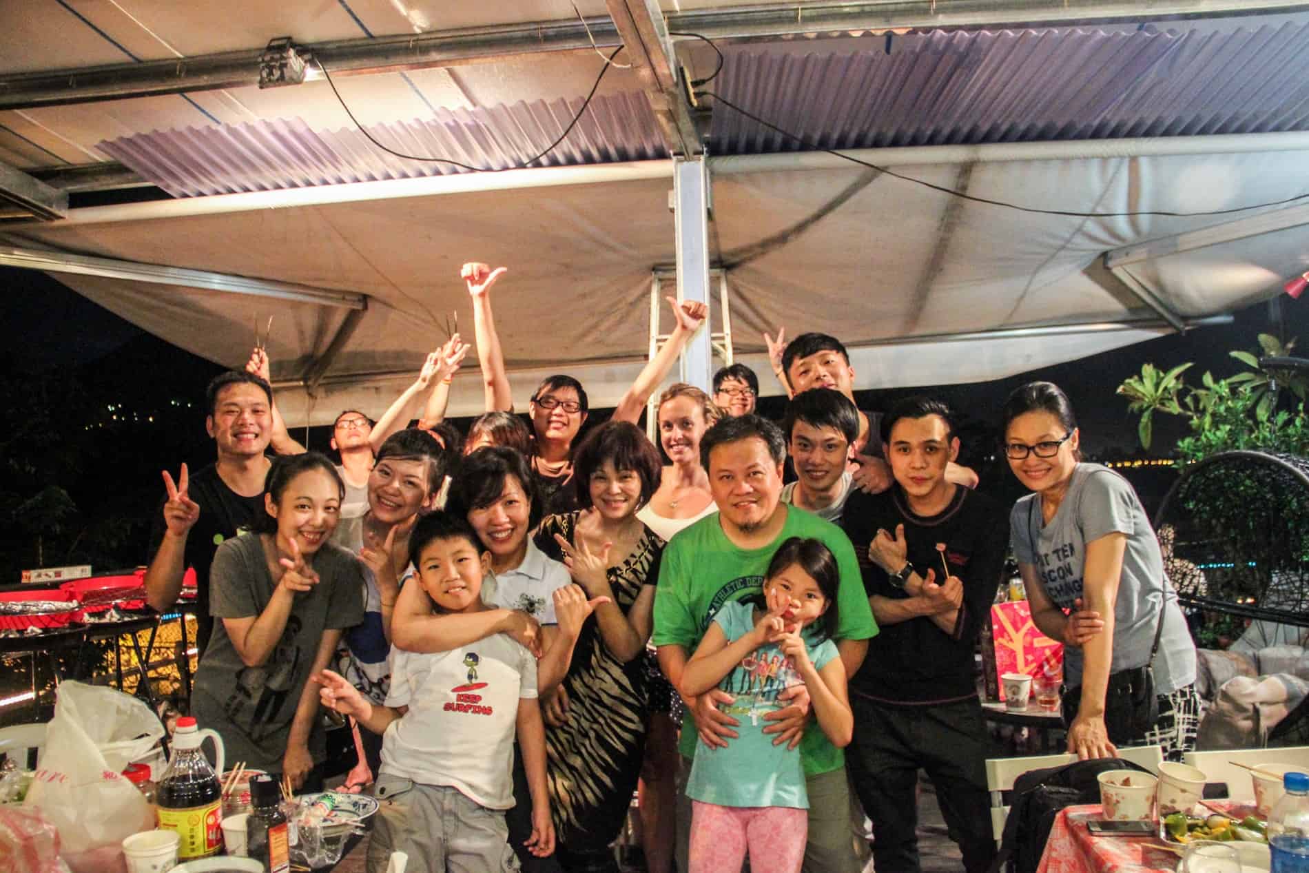 A western woman joins a group photo with Taiwanese locals. 