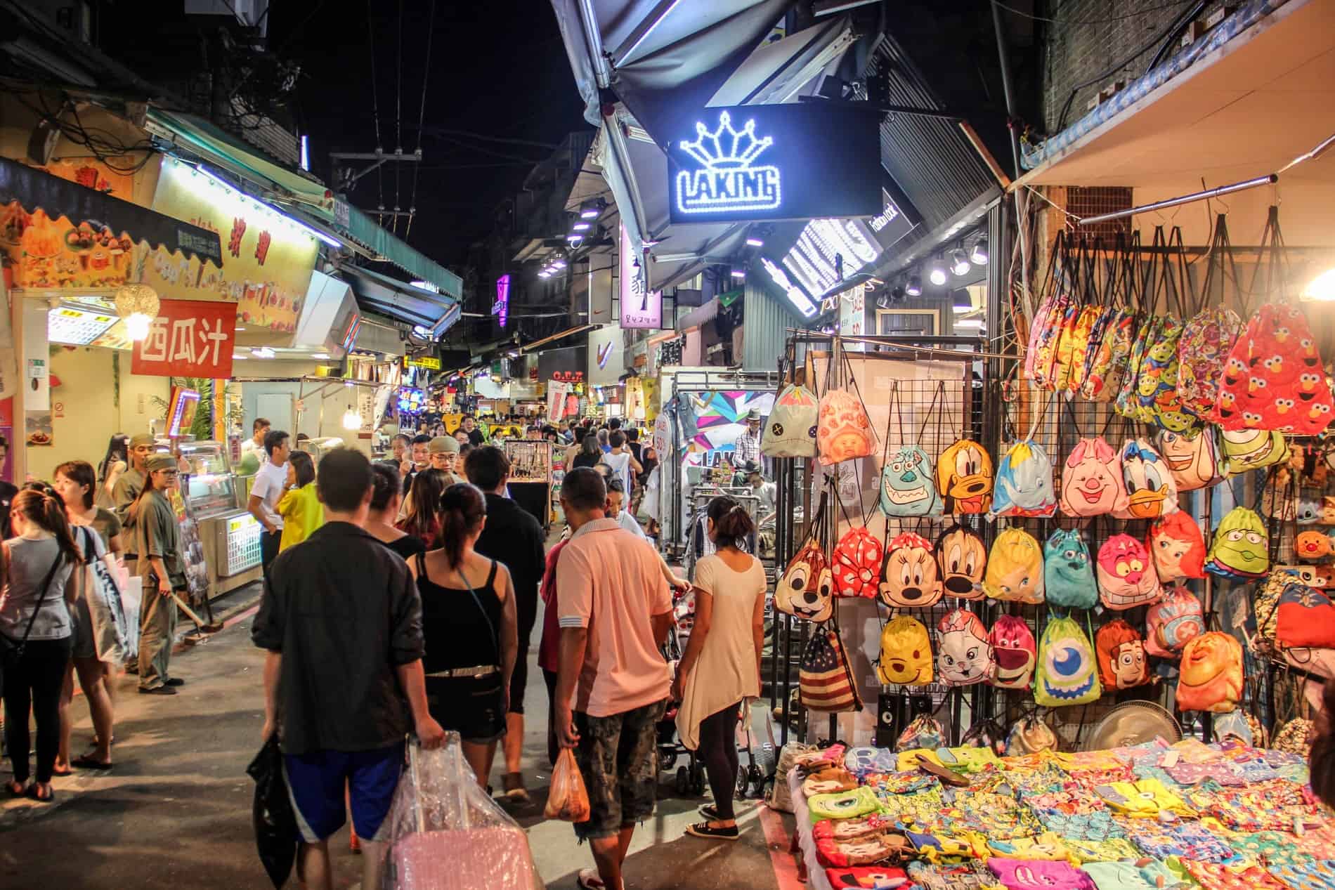 Taiwanese locals shopping at accessory and merchandise stalls at a Night Market in Taipei. 