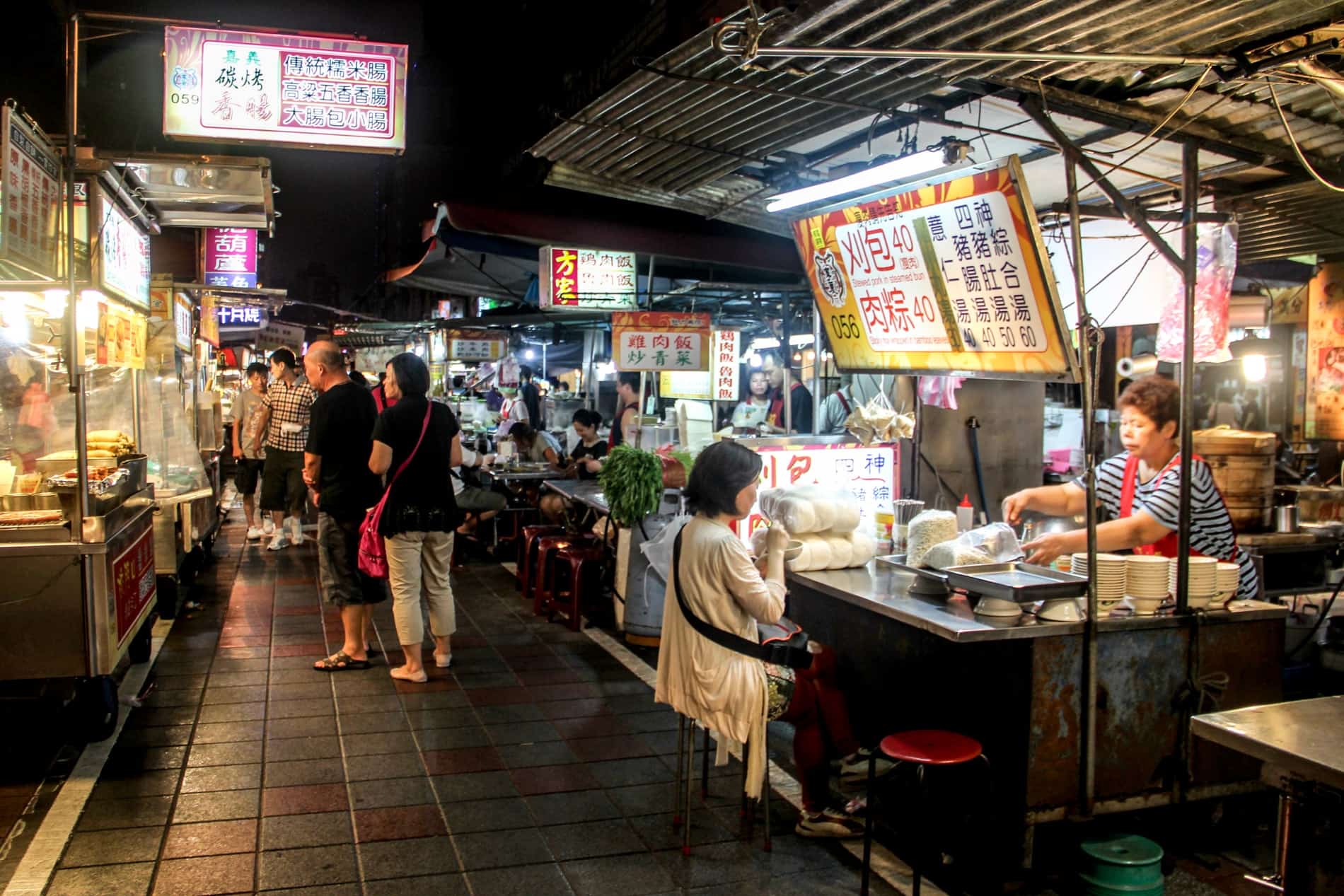 Taiwanese people browsing food stalls at a Night Market. 