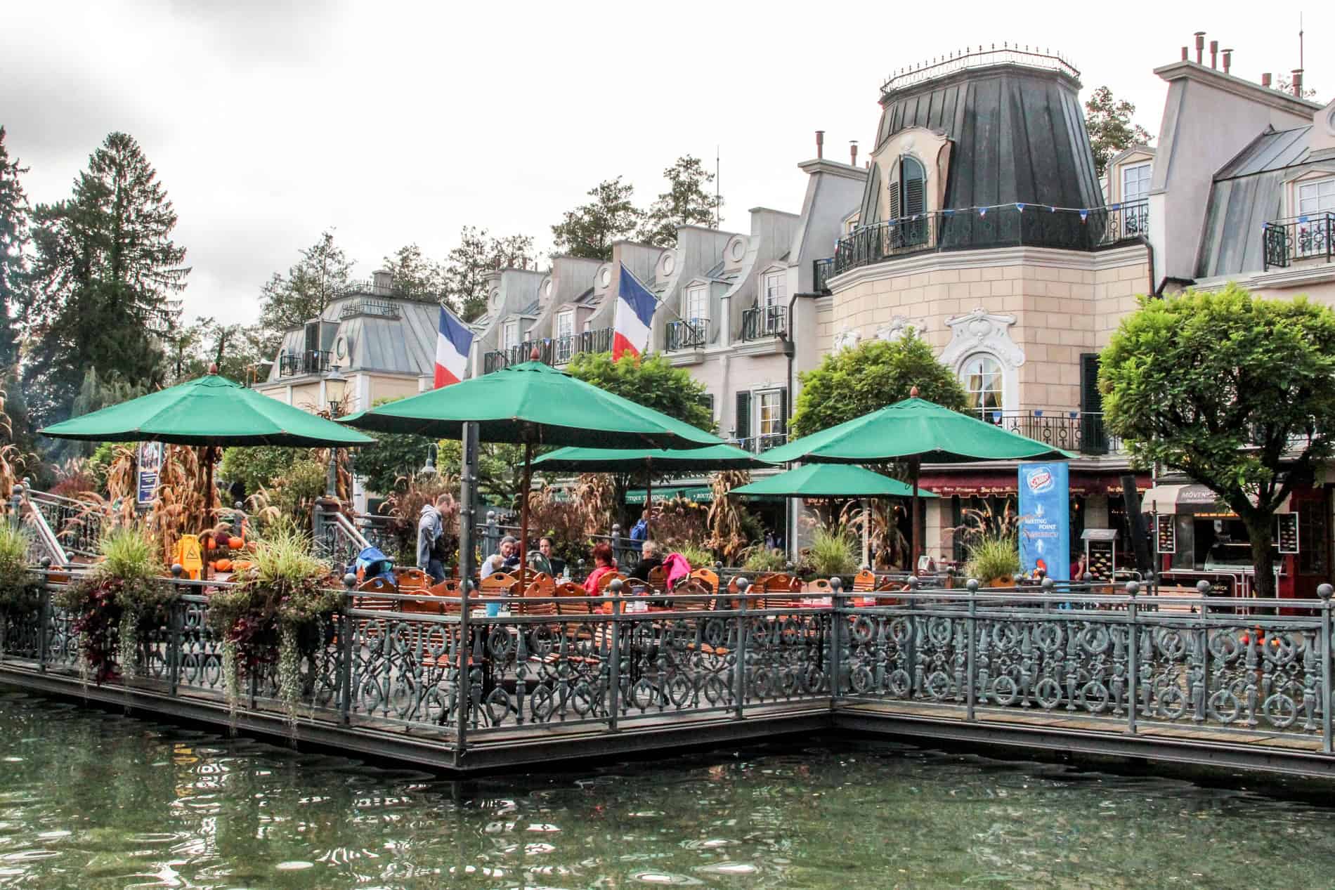 A replica French Chateaux building with outdoor dining terrace at Europa Park theme park in Germany. 