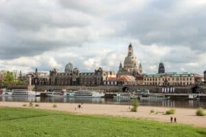 View of Dresden Aldstadt (old town) opulent architecture from the banks of the River Elbe lined with boats.