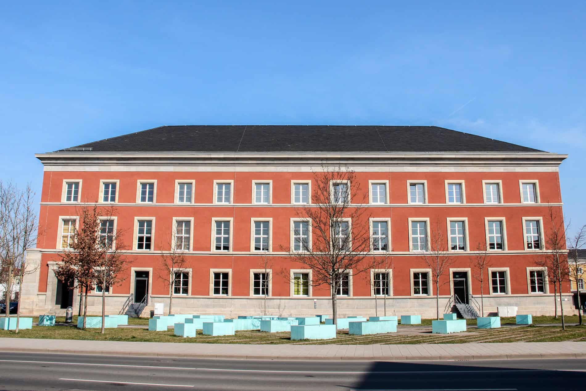 A long block building painted orange - an example of National Socialist architecture in Weimar, Germany. 