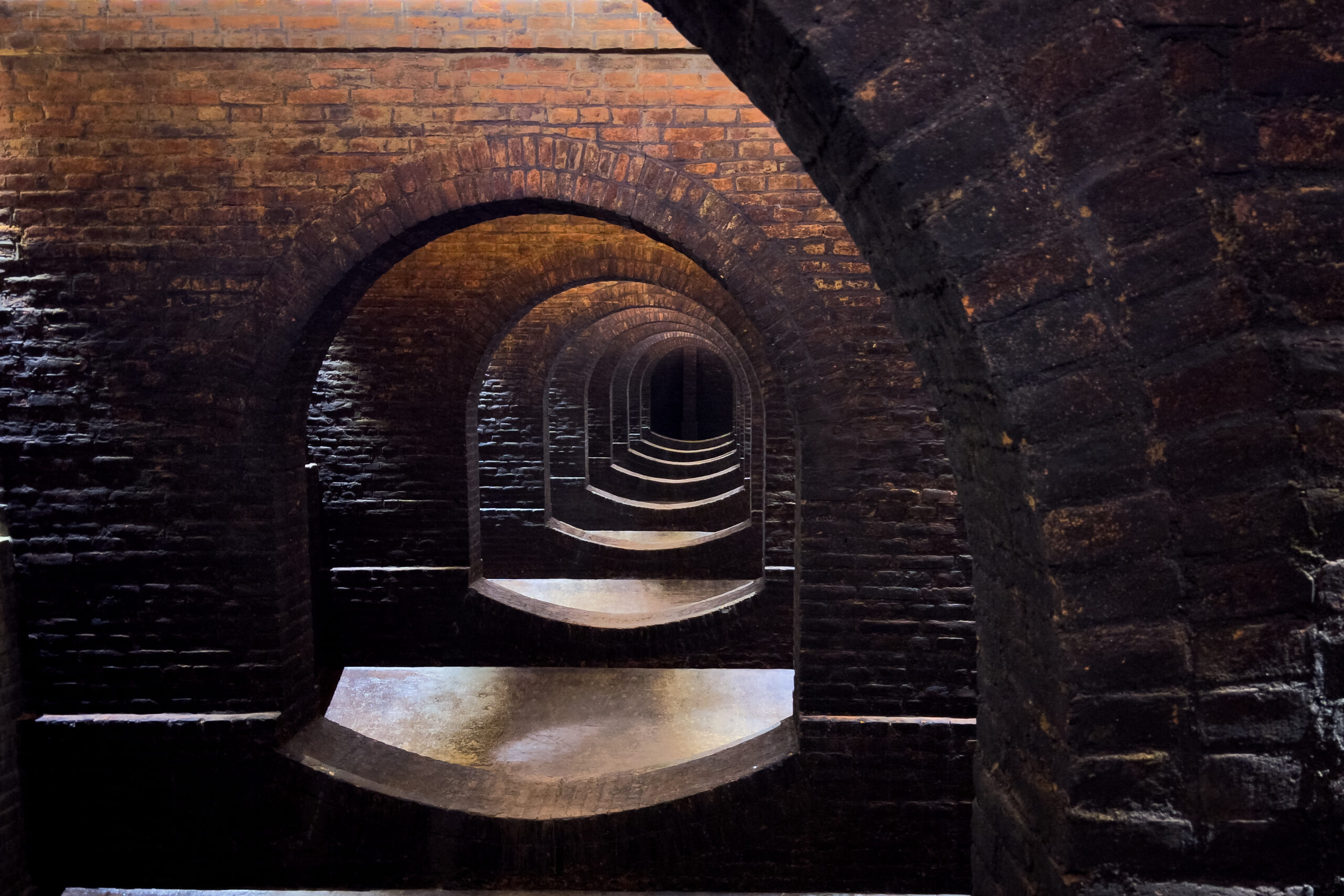 The illusion of a neverending tunnel created by the brick archways of an underground water reservoir.