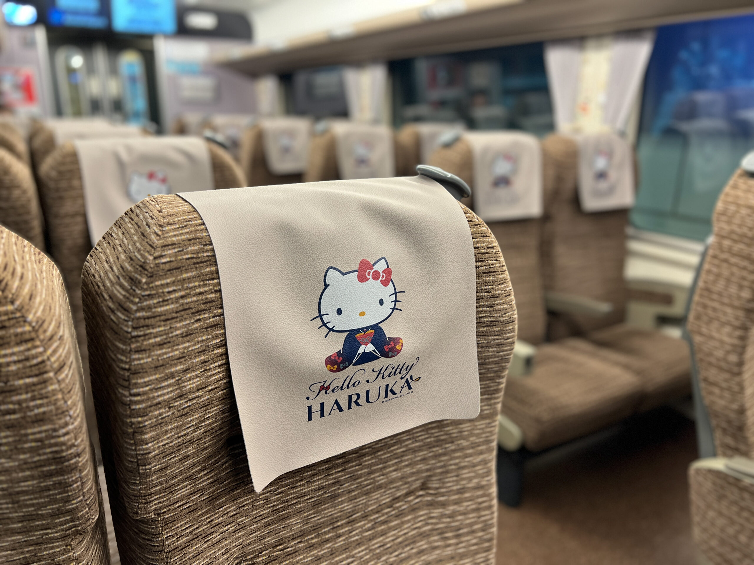 Close-up of Hello Kitty decorative details inside the HARUKA carriage featuring character prints on seat covers.