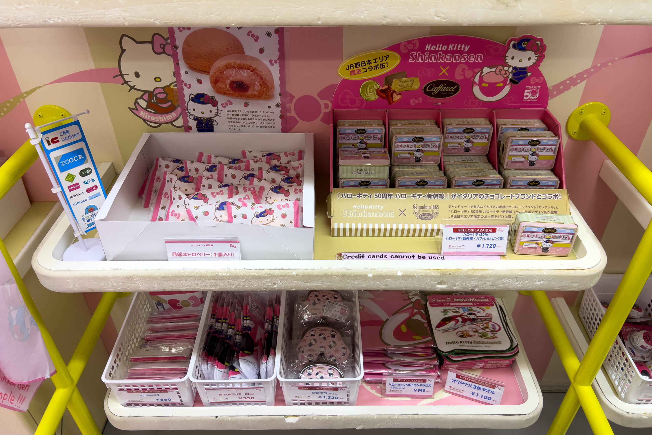 Hello Kitty Shinkansen merchandise including chocolate boxes and purses on the themed Japanese train.